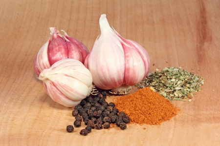 Fresh garlic and spices on a wooden tableの写真素材