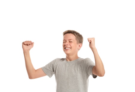 Happy teenage boy with arms raised. Isolated on white backgroundの写真素材