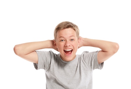 Excited teenage boy holding his head. Isolated on white backgroundの写真素材