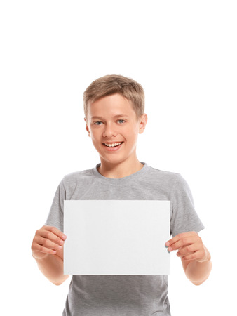 Smiling boy hold white blank paper. Isolated on white backgroundの写真素材