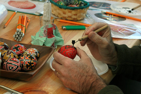 KYIV, UKRAINE - April 23, 2016. VI Ukrainian festival of Easter eggs. A man paints an Easter eggのeditorial素材