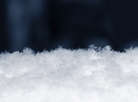 Natural snow with lots of snowflakes on blue background. Winter backgroundの写真素材