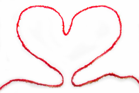 Red woolen thread in the shape of heart on white background. Valentines Day. Health, medicine. Heart...