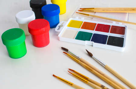water colour and gouache of paint and brush on white background. multi colored set for drawing.の写真素材