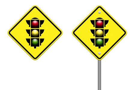 traffic light over yellow signの写真素材
