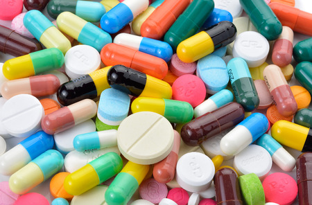drugs capsules and pills on white background
