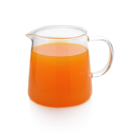 Orange juice in pitcher Isolated on white backgroundの写真素材
