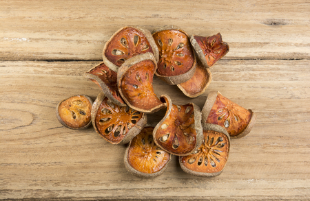 Dried quince isolated on wood backgroundの写真素材