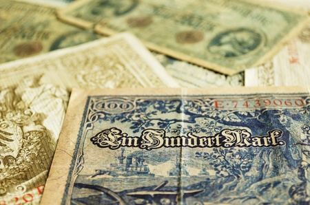 Part of an old German banknote from 1908. Other old banknotes can be seen blurred in the background.の写真素材