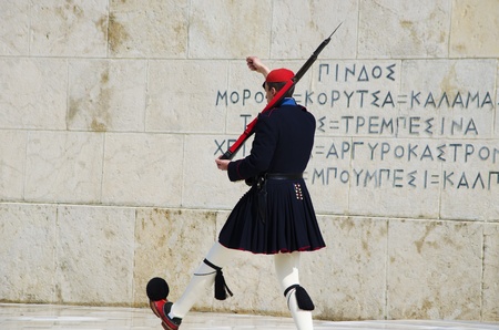 An Evzone, a member of an elite ceremonial unit of the Greek Army, guards the Tomb of the the Unknown Soldier at the Hellenic Parliament.のeditorial素材