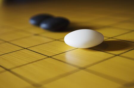 Close up shot of three go stones  Go is an ancient traditional Asian board game  Shallow depth of field の写真素材