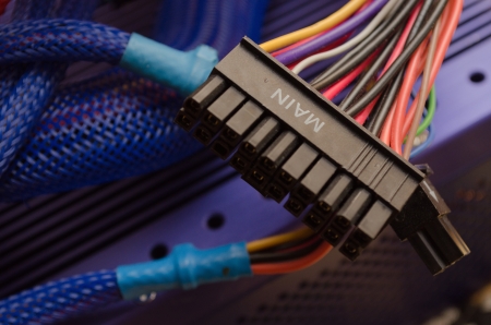 A blue power supply unit with the main power cable in focus 