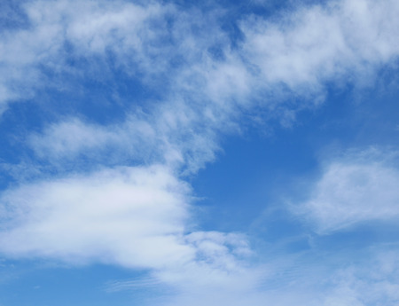 Fluffy clouds in the blu skyの写真素材