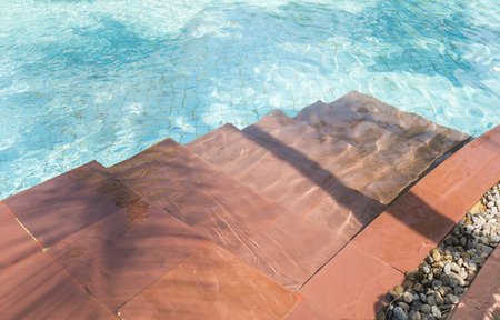 Blue swimming pool with the stair under sunlight in the afternoonの写真素材