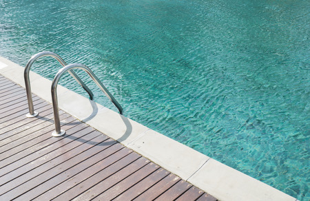 Blue swimming pool with the stair under sunlight in the afternoonの写真素材