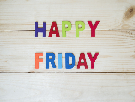 Word spelling "Happy Friday" on wood background (Business concept)の写真素材