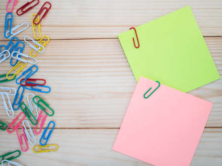 Colorful sticky note and paper clip on wood backgroundの写真素材