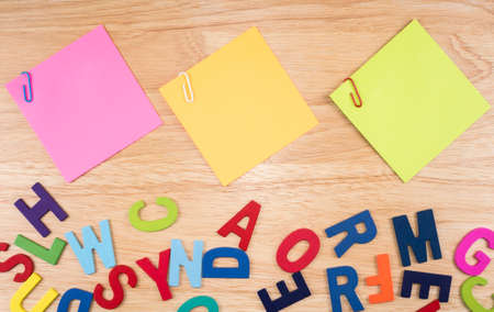 Colorful sticky note and paper clip on wood backgroundの写真素材