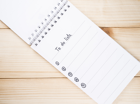 To do list on notebook with wood backgroundの写真素材