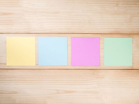 Colorful note paper / notepad on wood background