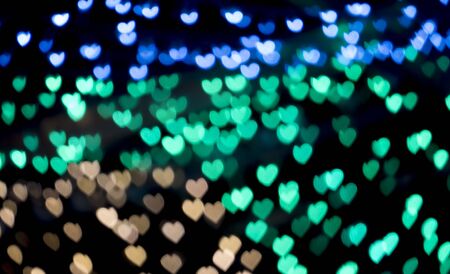 Heart shape colorful bokeh background from the light at the nightの写真素材