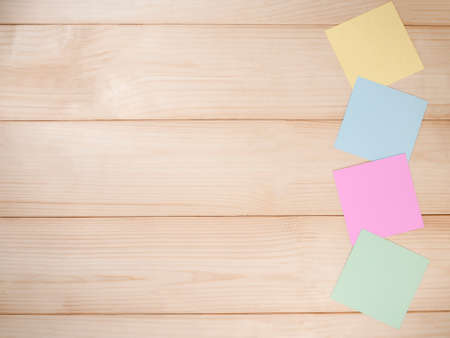 Blank colorful sticky note on brown wood background