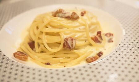 Spaghetti Carbonara with bacon on dish at the restaurant (italian food, pasta)の写真素材