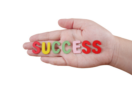 Word spell "success" by wooden font on woman palm with clipping path(Business concept)の写真素材