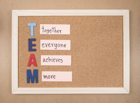 Word spelling "TEAM" by  wooden font on cork board (Business Concept)の写真素材