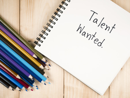 Handwriting Talent Wanted on blank notebook and color pencil with wood background