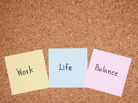 Word "Work Life Balance" on colorful note paper with cork board backgroundの写真素材