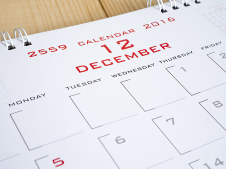 2016 December on calendar page, desk calendar on wood background (Selective focus)の写真素材