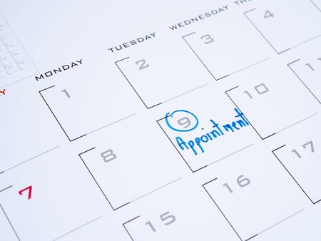 Close up handwriting word appointment on calendar desk (Selective focus)の写真素材