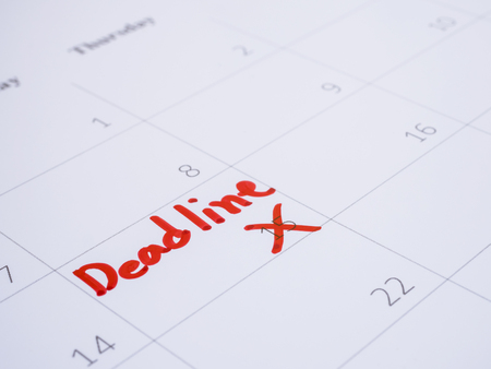 Close up handwriting word Deadline on calendar desk (Selective focus)の写真素材