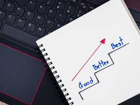 Handwriting Good Better Best and ladder on notebook with laptop keyboardの写真素材