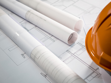 Architect rolls and plans, technical project drawing on the table (Selective focus)の写真素材