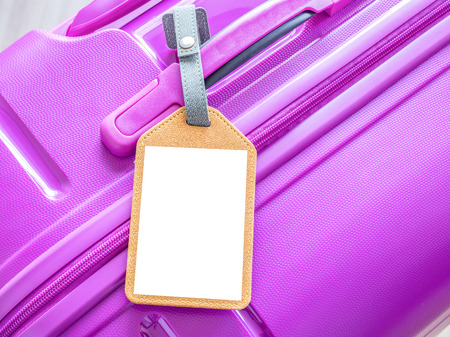 Close up of blank luggage tag on pink luggage bagの写真素材