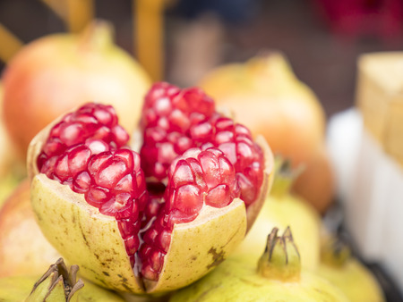 Closeup of half red pomegranate fruit (Selective focus)の写真素材
