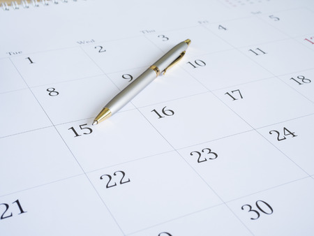 Close up pen put on calendar desk with top view (Selective focus)の写真素材
