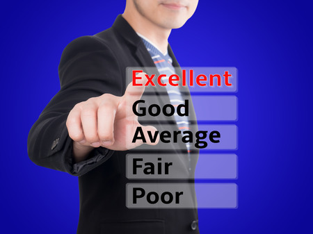 Casual business man point finger for rate performance evaluation in Excellent rating with blue backgroundの写真素材