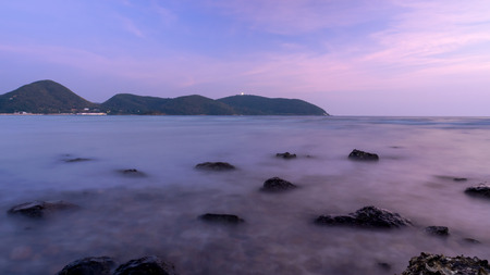 Long exposure of seascape with rock under blue sky in evening time.の写真素材
