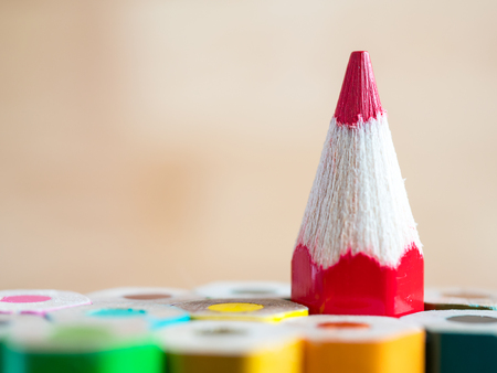 Red color pencil stand on various color pencil with wood blur background (Leadership concept)の写真素材