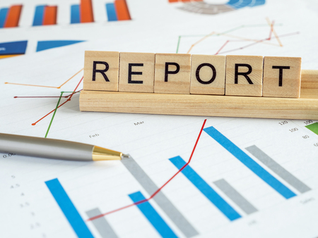Word spell "Report" over graph and chart report in the table (Business concept)の写真素材