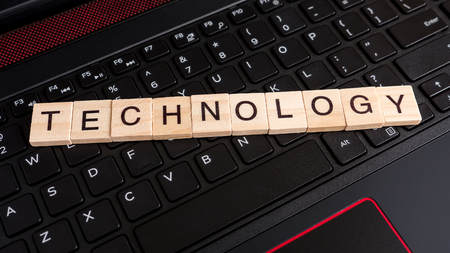 Word spell "Technology" over black laptop keyboard (Communication concept)の写真素材