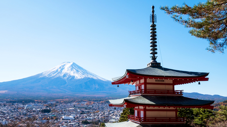 Landscape of Fuji mountain and red Pagoda with red leaf and dry tree under blue sky and sunlightのeditorial素材