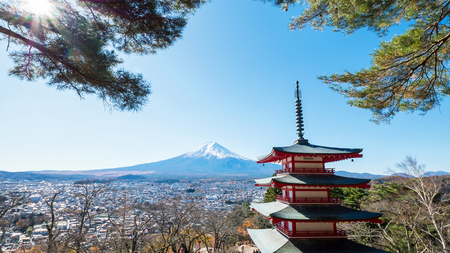 Landscape of Fuji mountain and red Pagoda with red leaf and dry tree under blue sky and sunlightのeditorial素材