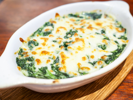 Closeup of Spinach with cheese on dish in the restaurant (Selective Focus)の写真素材