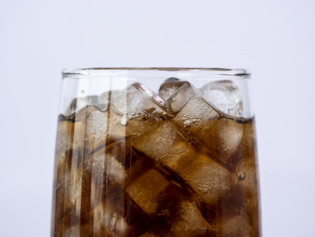 Selective fucus of cola soft drink with ice in the glass on isolated / white background