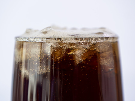 Selective fucus of cola soft drink with ice in the glass on isolated / white background
