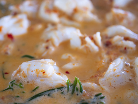 Close up of crab curry with chakhram leaves in the restaurant / delicious seafood in Thailand (Selective Focus)の写真素材